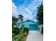 Charming blue home with a well-manicured front yard and inviting curb appeal at 11213 River Grove Dr, Orlando, FL 32817
