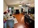 Open-concept living room showcasing hardwood floors, modern furniture, and a glimpse of the dining area at 11213 River Grove Dr, Orlando, FL 32817