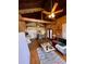 Cozy living room boasting rustic wood walls, beamed ceiling, and inviting seating area at 11213 River Grove Dr, Orlando, FL 32817