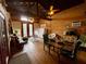 Rustic living room with wood paneled walls, exposed beam ceiling, and comfortable seating arrangement at 11213 River Grove Dr, Orlando, FL 32817