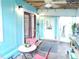 Charming patio area with colorful walls, cozy seating, and natural light for outdoor enjoyment at 11213 River Grove Dr, Orlando, FL 32817