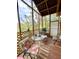 Screened porch with lattice trim and outdoor view, furnished with a seating area at 11213 River Grove Dr, Orlando, FL 32817