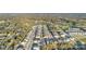 Aerial view of a neighborhood with lush greenery, a golf course, and mature trees surrounding the homes at 1129 Blue Garden Dr, Deland, FL 32720