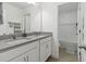Bathroom features double sinks, a framed mirror, white cabinets and views of the shower and toilet at 1129 Blue Garden Dr, Deland, FL 32720