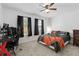 This bedroom features carpet floors, a ceiling fan, a queen bed, a desk and a TV at 1129 Blue Garden Dr, Deland, FL 32720