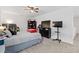 This bedroom has carpet floors, a ceiling fan, a queen bed, a shelf, and a TV on a dresser at 1129 Blue Garden Dr, Deland, FL 32720