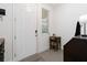 Bright entryway featuring a white front door, neutral walls, tile flooring, and coat rack at 1129 Blue Garden Dr, Deland, FL 32720