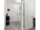 Bright entryway featuring a white front door, neutral walls, tile flooring, and coat rack at 1129 Blue Garden Dr, Deland, FL 32720