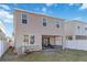The back of the house features a covered patio with seating and a well-maintained backyard at 1129 Blue Garden Dr, Deland, FL 32720