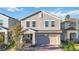 Two-story home with a front porch, landscaped yard, and attached garage at 1129 Blue Garden Dr, Deland, FL 32720