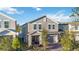 Two-story home with front yard landscaping, a covered porch, and a two-car garage at 1129 Blue Garden Dr, Deland, FL 32720
