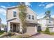 Charming two-story home boasts a neutral stucco facade, complemented by stone accents and a brick driveway at 1129 Blue Garden Dr, Deland, FL 32720