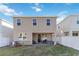 The back of the home featuring a covered patio with seating and a backyard at 1129 Blue Garden Dr, Deland, FL 32720