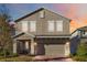 Charming two-story home boasts neutral stucco, stone accents, brick driveway and a welcoming covered front porch at 1129 Blue Garden Dr, Deland, FL 32720