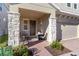 Inviting front porch with stone pillars and a cozy seating area, perfect for relaxing and enjoying the neighborhood at 1129 Blue Garden Dr, Deland, FL 32720