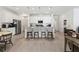 Open concept kitchen with white cabinetry, a center island with seating, and stainless steel appliances at 1129 Blue Garden Dr, Deland, FL 32720