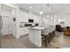 Well-lit kitchen features bar seating, white cabinetry, and a stainless steel appliance package at 1129 Blue Garden Dr, Deland, FL 32720
