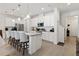 Modern kitchen with white cabinets, a center island with seating, and stainless steel appliances at 1129 Blue Garden Dr, Deland, FL 32720