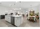 Spacious open-concept living space features tile floors and great lighting adjoining the kitchen and dining areas at 1129 Blue Garden Dr, Deland, FL 32720