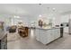 Open-concept living space features tile floors and great lighting adjoining the kitchen and dining areas at 1129 Blue Garden Dr, Deland, FL 32720