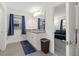 Well-lit main bathroom with double sinks, framed mirror, tile floors, and views into the main bedroom at 1129 Blue Garden Dr, Deland, FL 32720