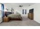 Spacious main bedroom features a ceiling fan, carpet floors, natural light, and a wooden dresser at 1129 Blue Garden Dr, Deland, FL 32720