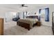 Spacious main bedroom features a ceiling fan, carpet floors, natural light, and a seating area at 1129 Blue Garden Dr, Deland, FL 32720