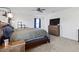 Spacious main bedroom features a ceiling fan, carpet floors, natural light, and a wooden dresser at 1129 Blue Garden Dr, Deland, FL 32720