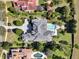 Overhead view of a luxury property boasting a large pool, manicured lawns, and meticulously designed landscaping at 11306 Bridge House Rd, Windermere, FL 34786