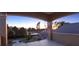 Balcony with decorative iron railing offering scenic views of the backyard, trees, and sunset at 11306 Bridge House Rd, Windermere, FL 34786