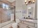 Bathroom featuring granite countertops, mosaic tile accents, and a glass-enclosed shower at 11306 Bridge House Rd, Windermere, FL 34786