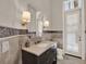 Elegant bathroom featuring marble countertops, mosaic tile accents, and shuttered door at 11306 Bridge House Rd, Windermere, FL 34786