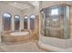 Stunning bathroom featuring a soaking tub, large shower stall and arched windows at 11306 Bridge House Rd, Windermere, FL 34786