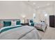 Bright bedroom featuring two beds with teal accents, bedside table, and ample natural light at 11306 Bridge House Rd, Windermere, FL 34786