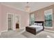 Stylish bedroom with patterned wallpaper, light pink walls, and a modern chandelier at 11306 Bridge House Rd, Windermere, FL 34786