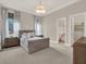 Serene bedroom showcasing neutral tones, plush carpeting, and well-lit windows at 11306 Bridge House Rd, Windermere, FL 34786