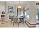 Elegant dining room with fireplace, chandelier and view of the outdoor lanai at 11306 Bridge House Rd, Windermere, FL 34786