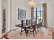 Formal dining room with stylish chandelier, large window, and elegant table for sophisticated dining at 11306 Bridge House Rd, Windermere, FL 34786