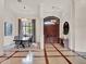 Grand foyer boasts high ceilings, elegant chandelier, and ornate wooden doors that showcase the home's luxury at 11306 Bridge House Rd, Windermere, FL 34786