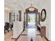 A grand foyer with double doors open to reveal a lush green landscape at 11306 Bridge House Rd, Windermere, FL 34786