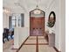 A grand foyer features a crystal chandelier, double doors, and elegant marble flooring with wood accents at 11306 Bridge House Rd, Windermere, FL 34786