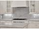 Gourmet kitchen with marble backsplash, premium appliances and custom white cabinetry at 11306 Bridge House Rd, Windermere, FL 34786