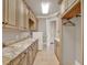 Spacious laundry room with ample counter space, custom cabinetry, and modern appliances at 11306 Bridge House Rd, Windermere, FL 34786