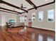 Spacious living room features ceiling beams, hardwood floors, and many windows at 11306 Bridge House Rd, Windermere, FL 34786