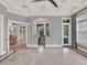 Bright living room featuring a tray ceiling, tiled floors, and view to the kitchen or bar area at 11306 Bridge House Rd, Windermere, FL 34786