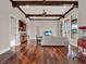 Open living room with hardwood floors, coffered ceilings and a convenient bar at 11306 Bridge House Rd, Windermere, FL 34786