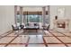 An elegant living room features a stone fireplace, large windows, and stylish decor at 11306 Bridge House Rd, Windermere, FL 34786