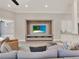 Comfortable living room features an entertainment center and view to the kitchen at 11306 Bridge House Rd, Windermere, FL 34786