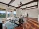 Bright living room featuring coffered ceilings, windows and hardwood flooring at 11306 Bridge House Rd, Windermere, FL 34786