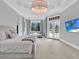 Luxurious main bedroom with a chandelier, sitting area, and views to the pool at 11306 Bridge House Rd, Windermere, FL 34786